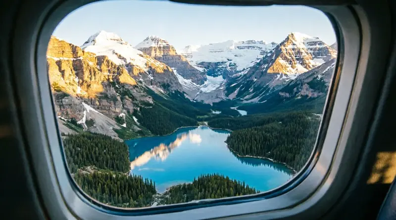 Canadian Rockies mountain range with turquoise glacial lakes seen from above